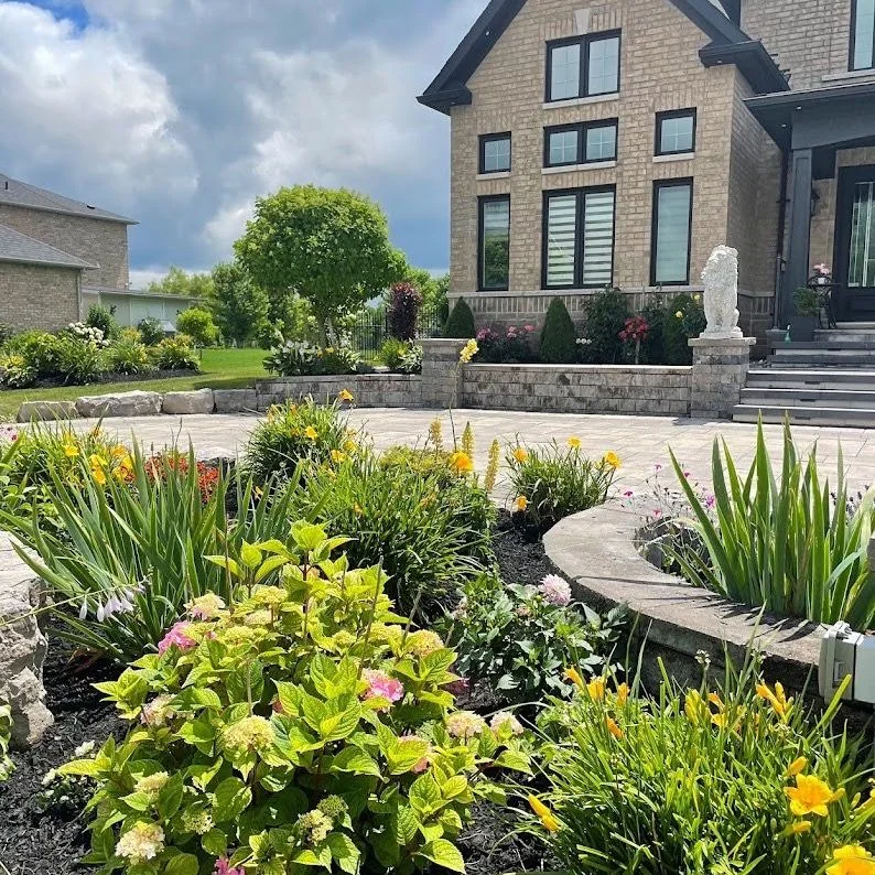 Layered flowering garden surrounding a curved front terrace